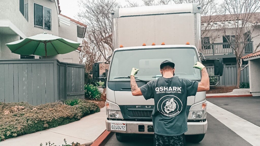 moving truck and a mover getting ready for service