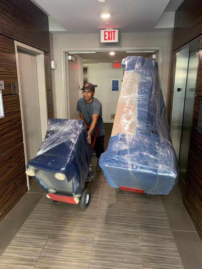 a picture of movers moving a night stand and a couch