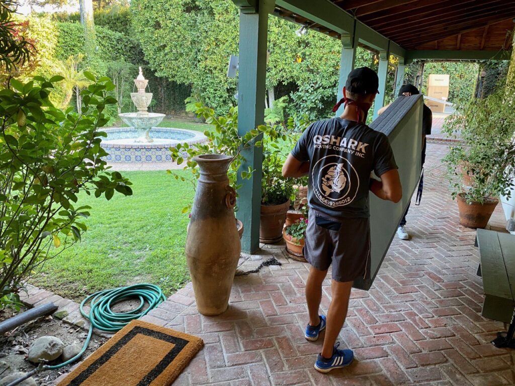 a picture of movers moving a mattress