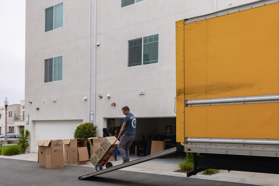 a picture of qshark movers helping unload a moving truck