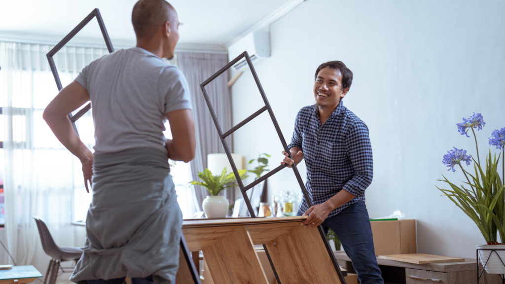 a picture of two san diego students moving furniture