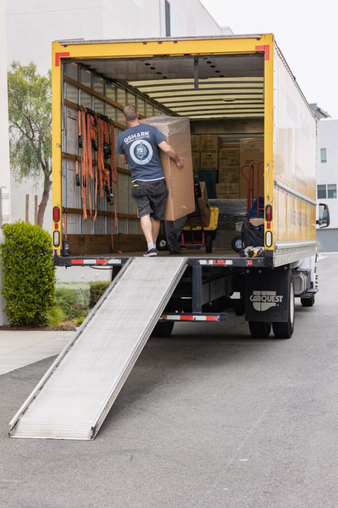 a picture of qshark mover loading a moving truck