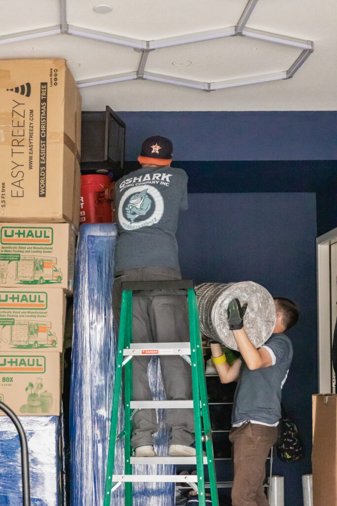 a picture of qshark movers loading a garage
