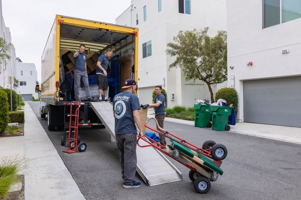 a picture a qshark movers using different moving dollies for moving customers items